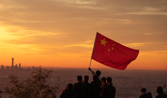A group of people standing on top of a hill