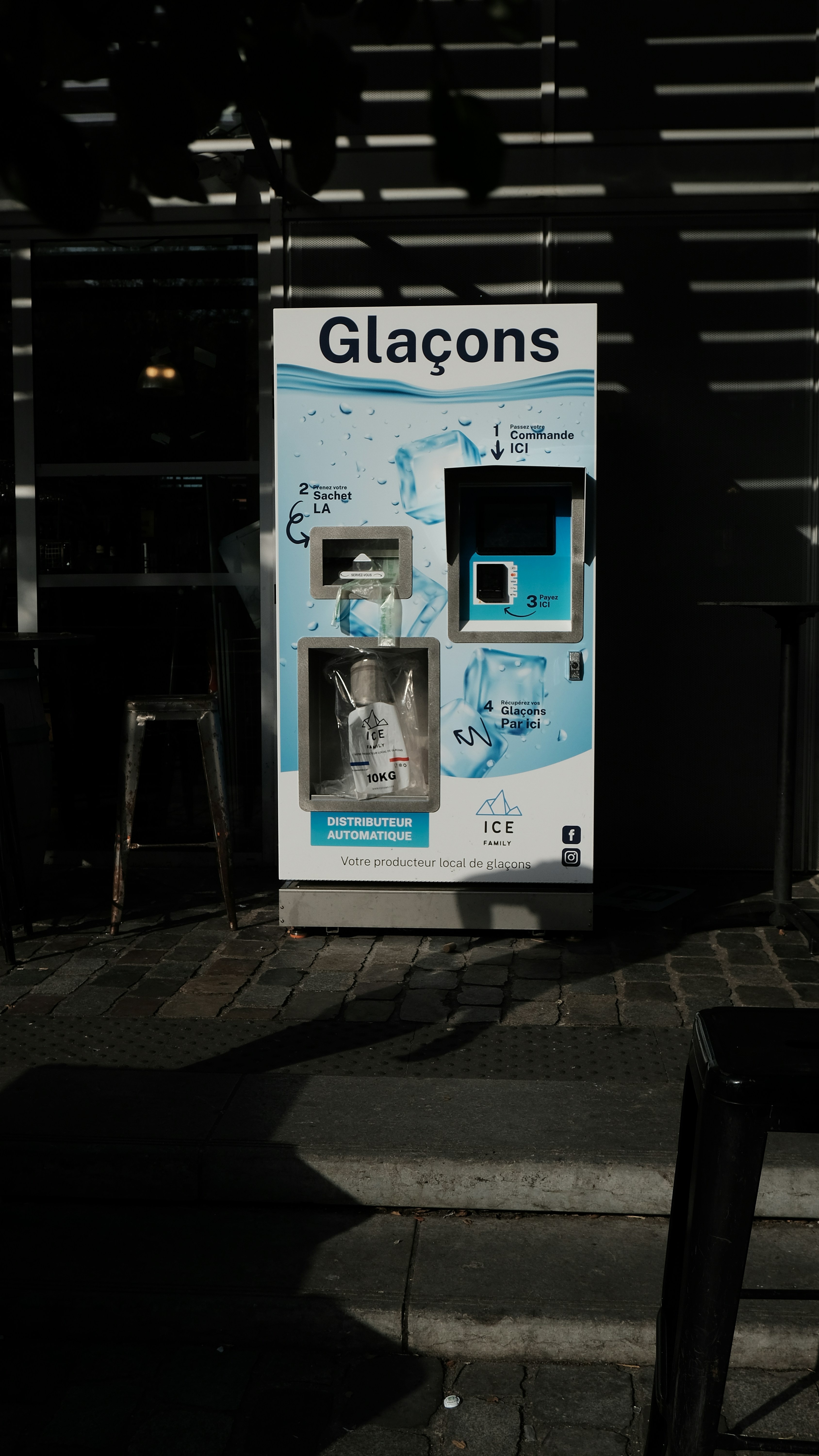 A water dispenser sitting on the side of a road