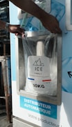 A person putting a bag of ice into a machine