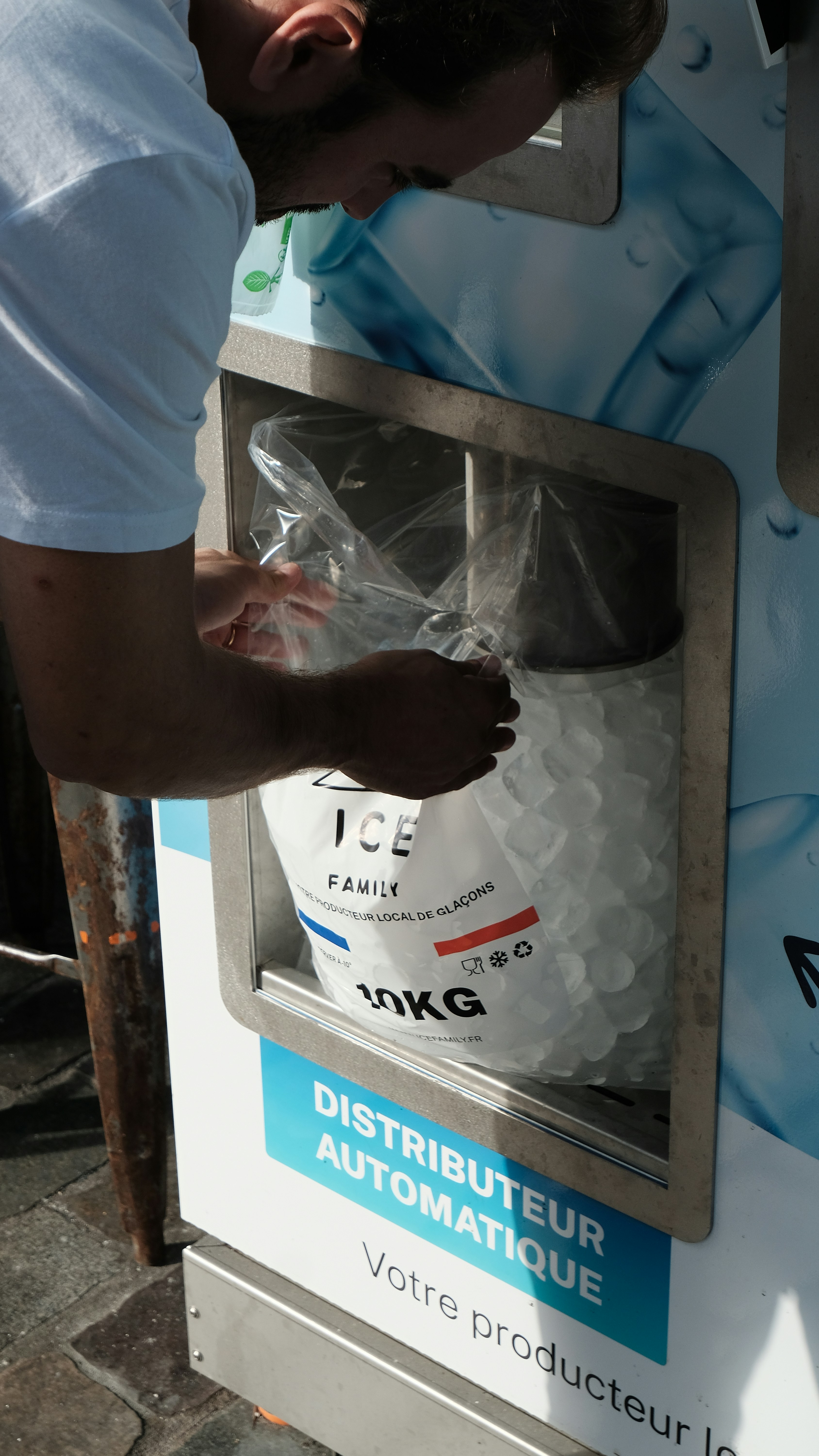 A man is putting something in a machine