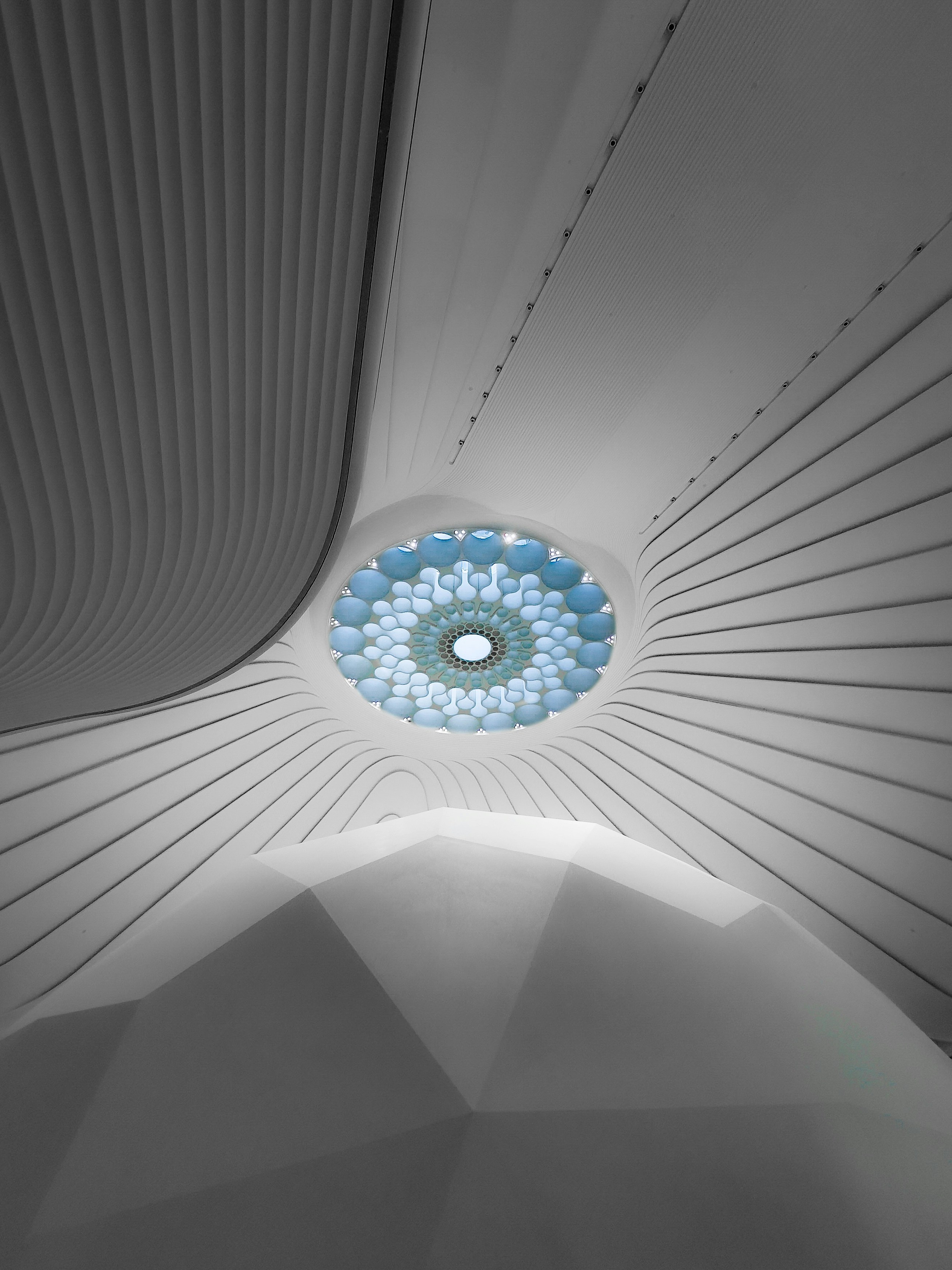 The ceiling of a building with a circular light fixture