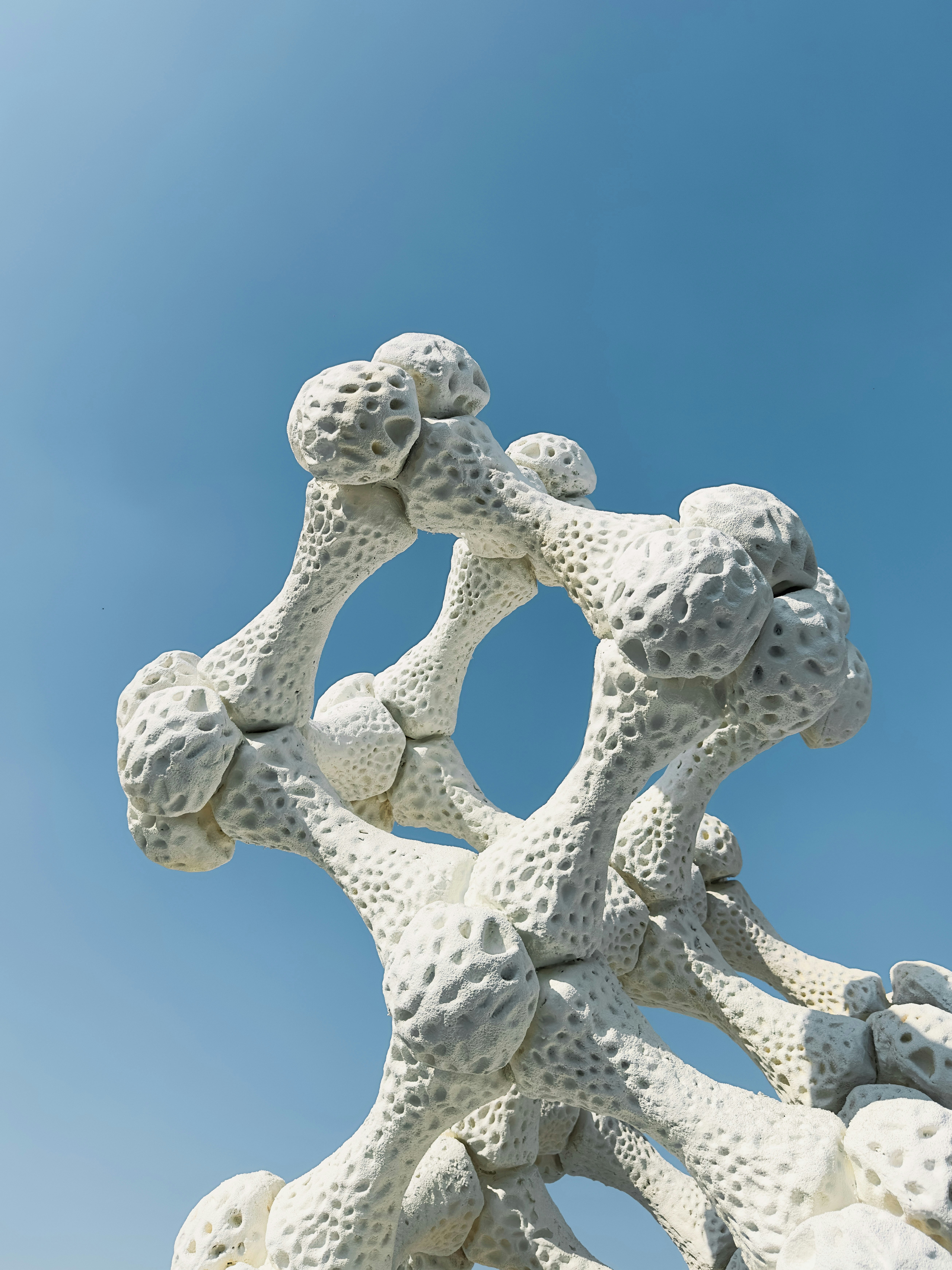A white sculpture with a blue sky in the background