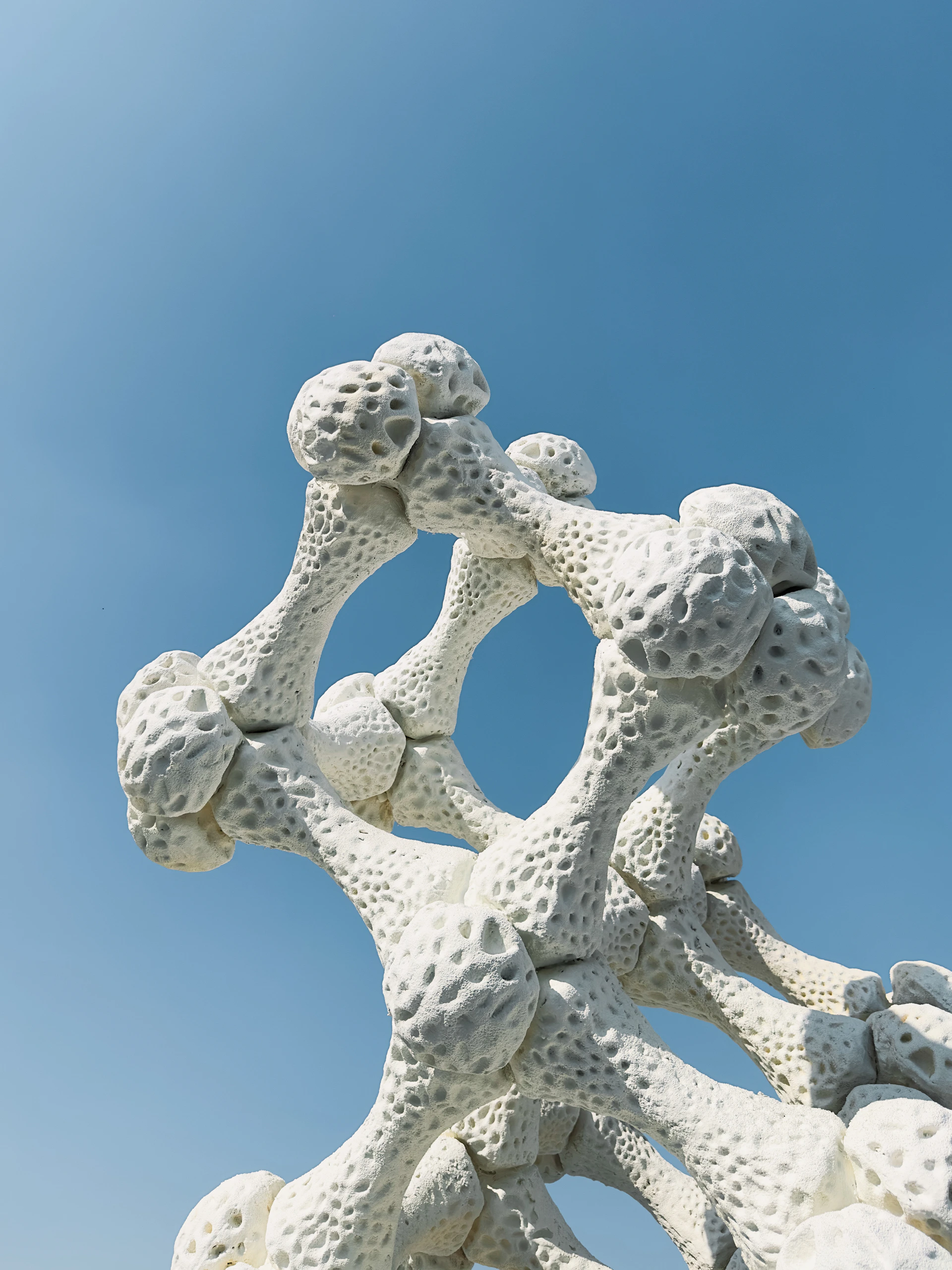 A white sculpture with a blue sky in the background