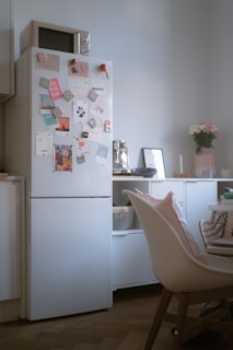 A white refrigerator freezer sitting inside of a kitchen