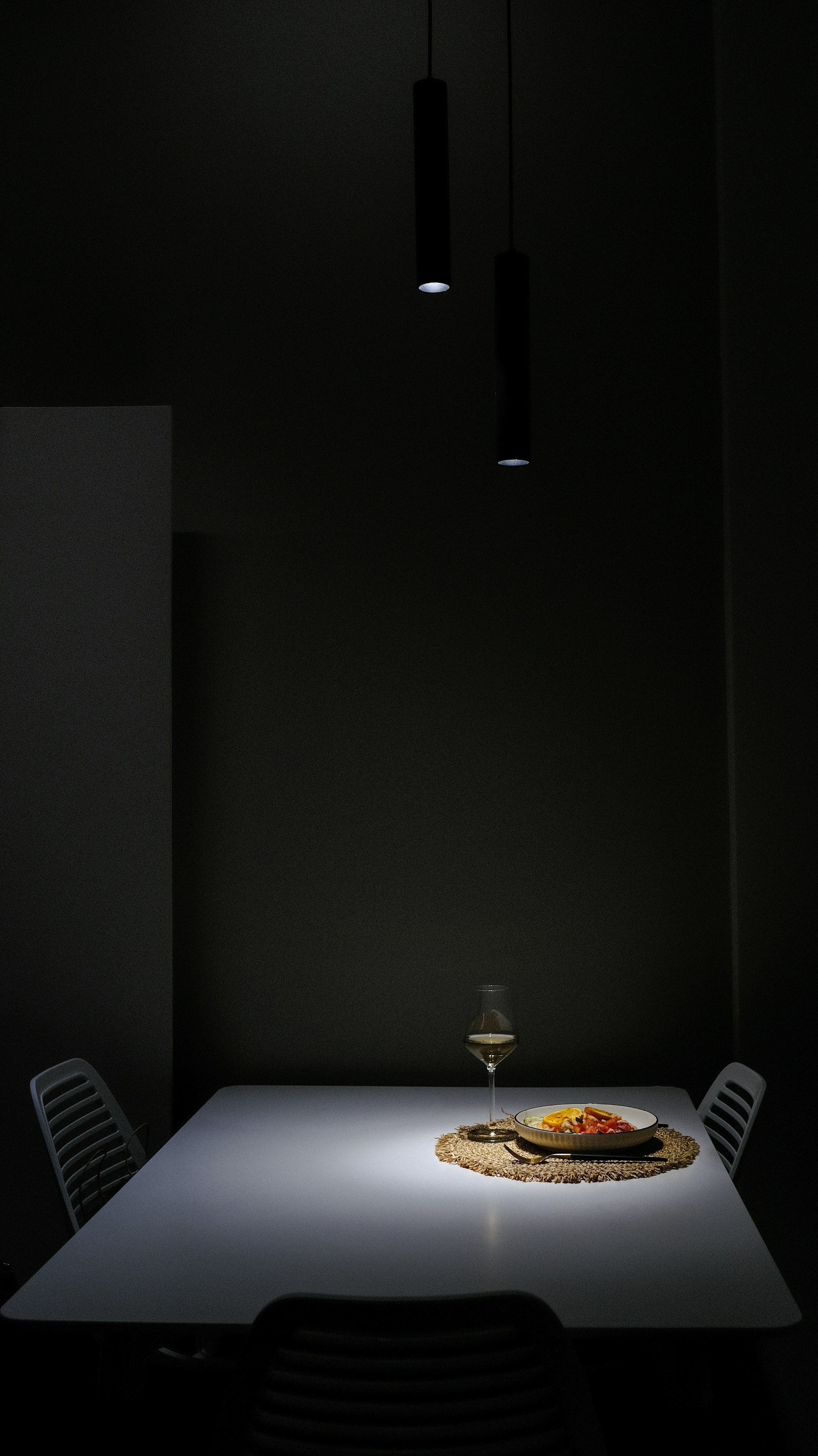 A table with a plate of food on it in a dark room