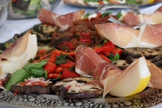 A platter of meats and vegetables on a table