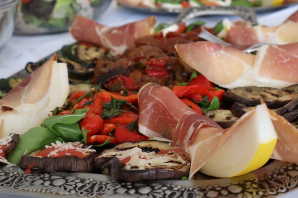 A platter of meats and vegetables on a table
