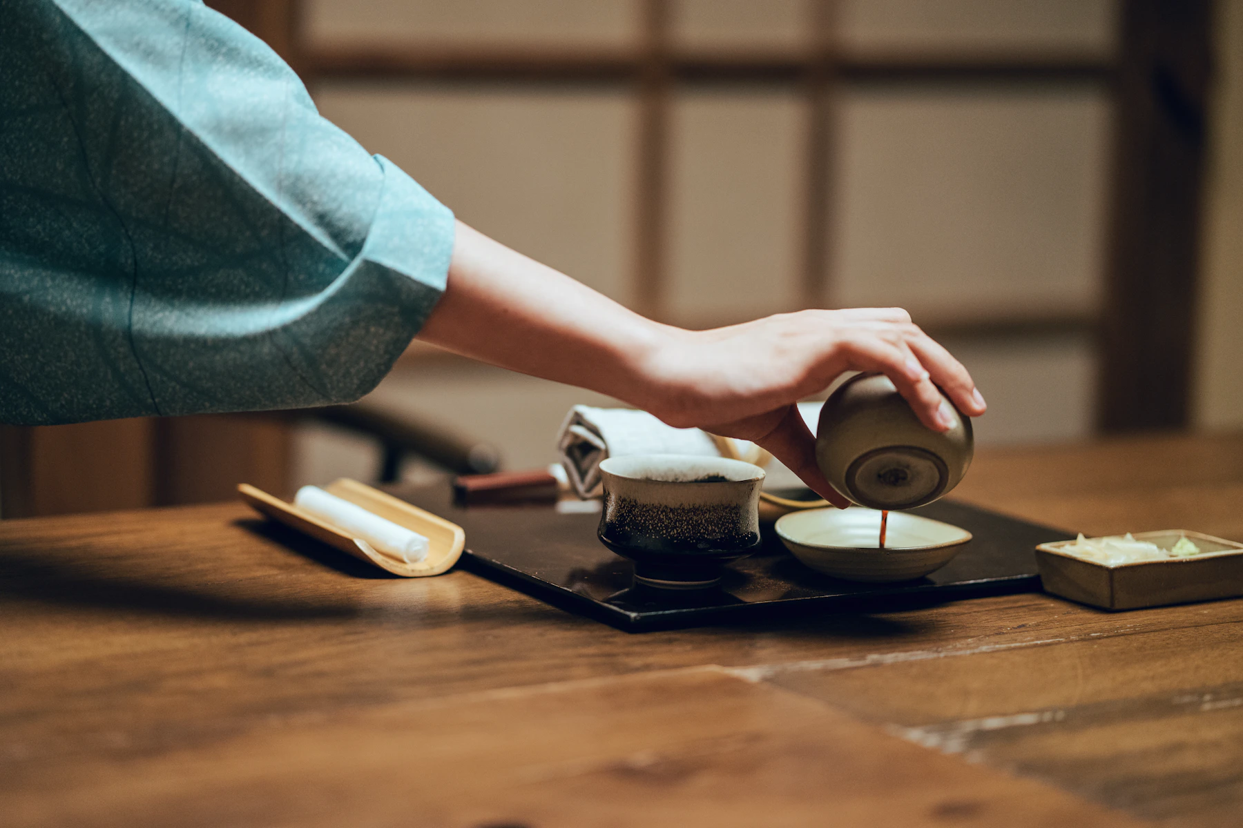 Tea being poured into a cup during a calm beverage ritual