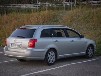 A silver car parked in a parking lot
