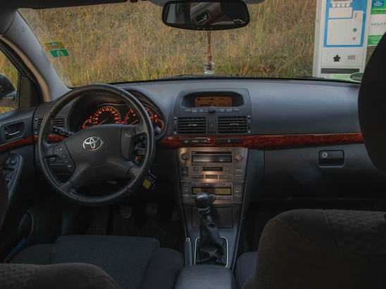 The interior of a car with a dashboard and dashboard lights