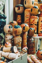 A group of wooden dolls sitting next to each other