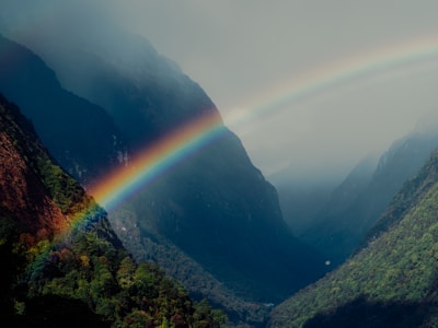A rainbow in the middle of a mountain range