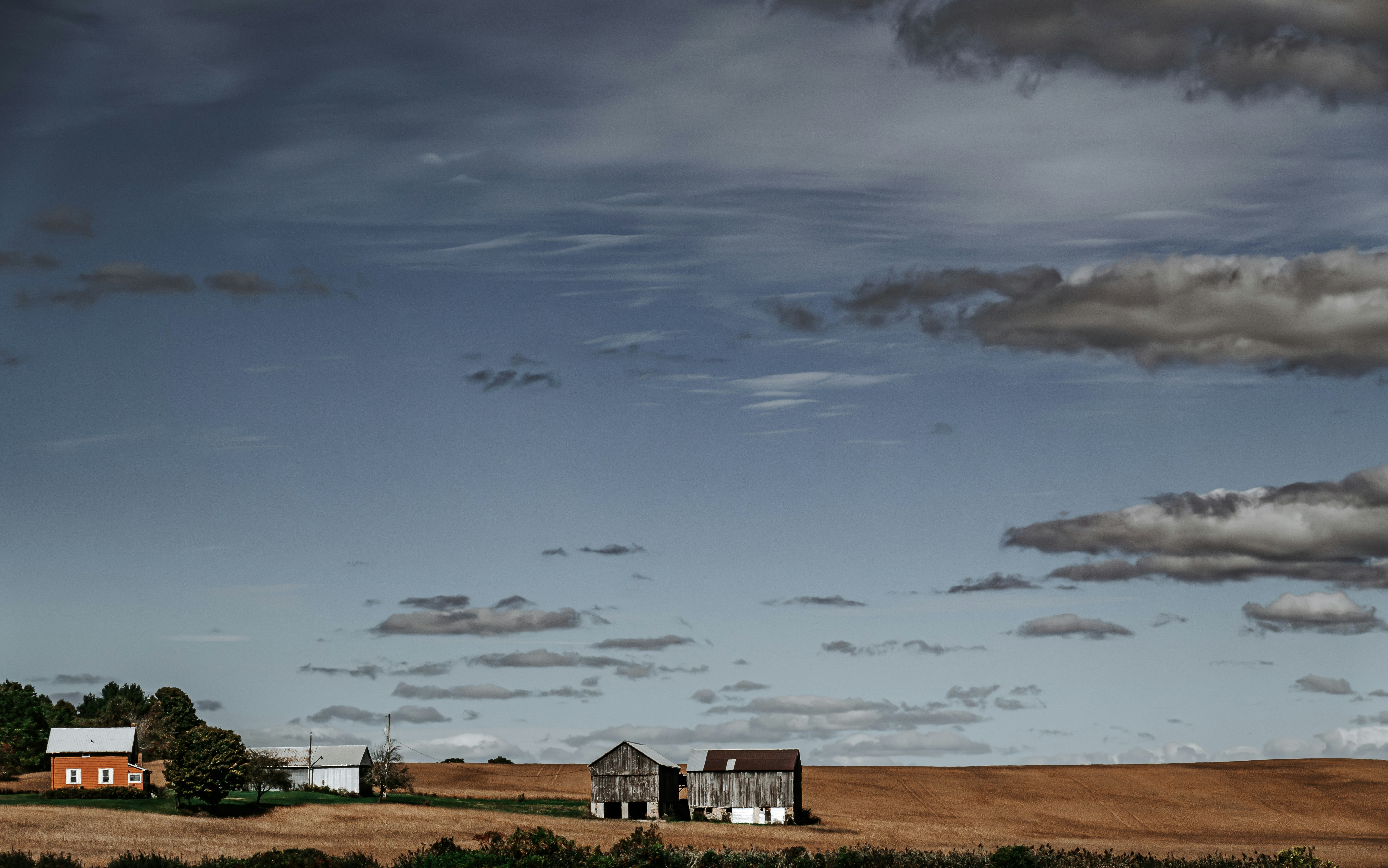 A large field with a few houses in it