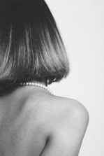 A black and white photo of a woman with short hair