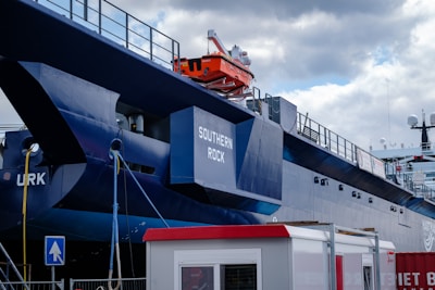 A large blue and white boat docked at a dock