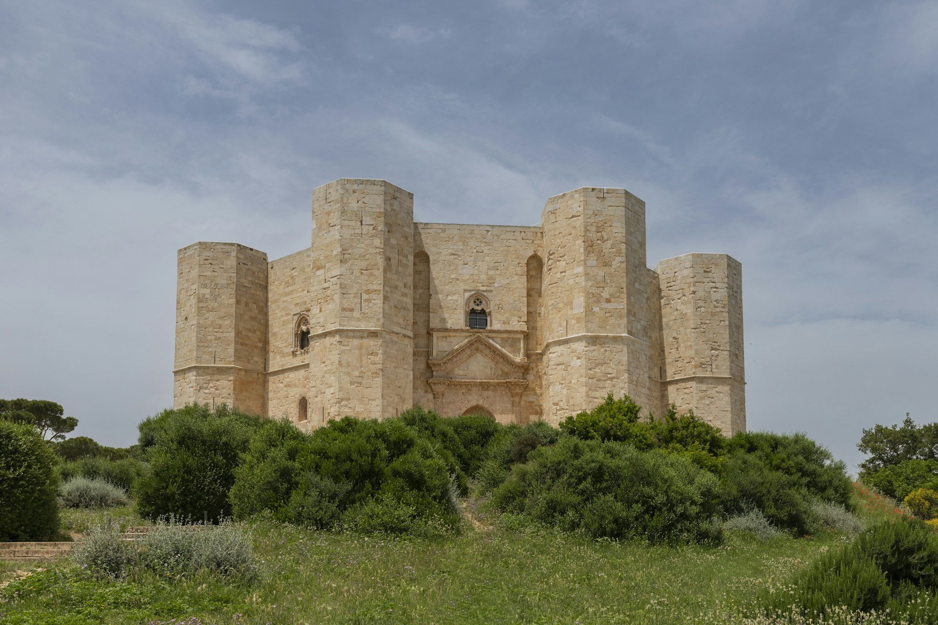 A large building with a tower in the middle of a field