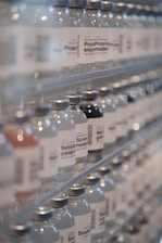 Bottles of water are lined up on a shelf
