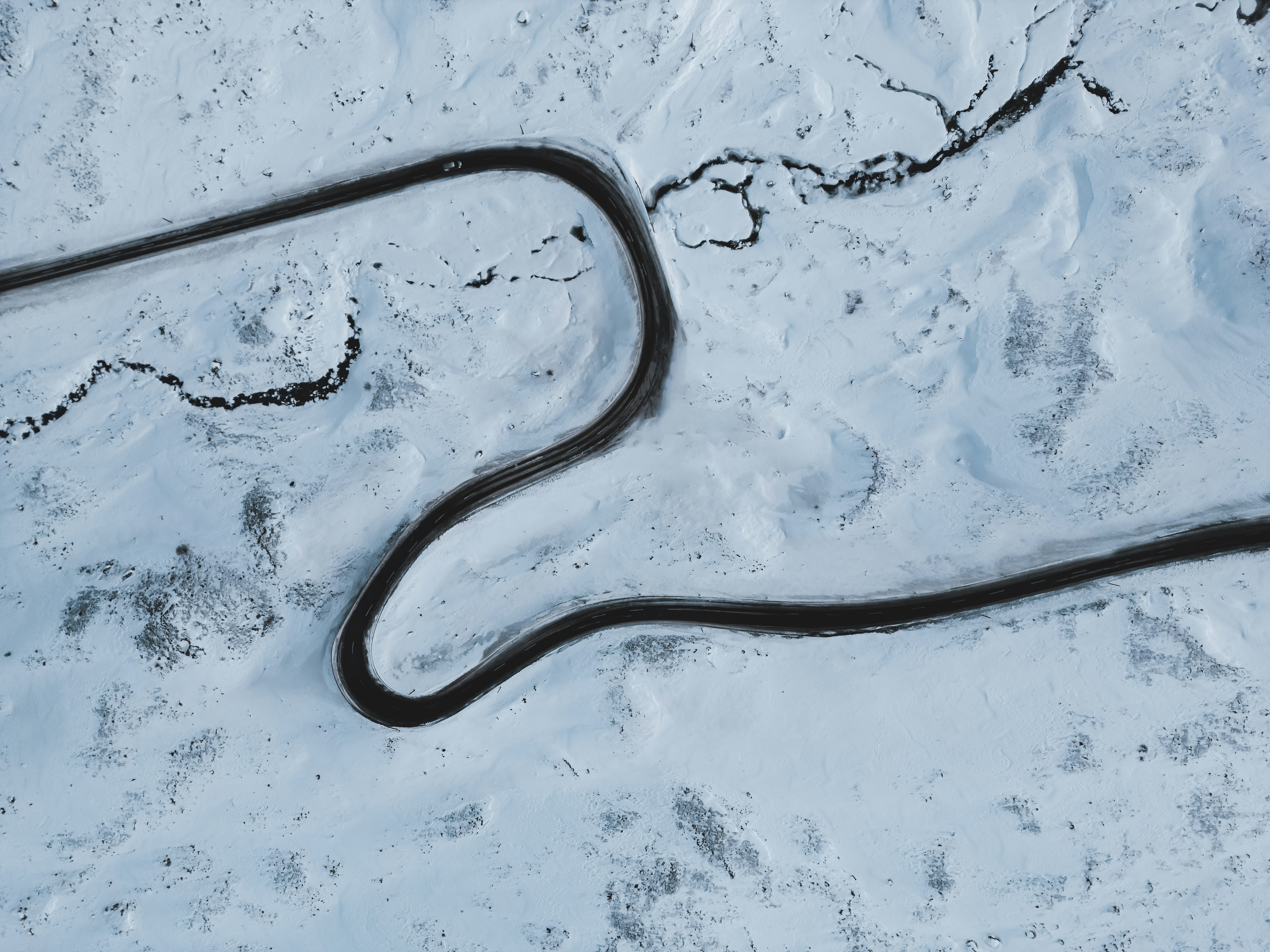 A long line of road going through the snow