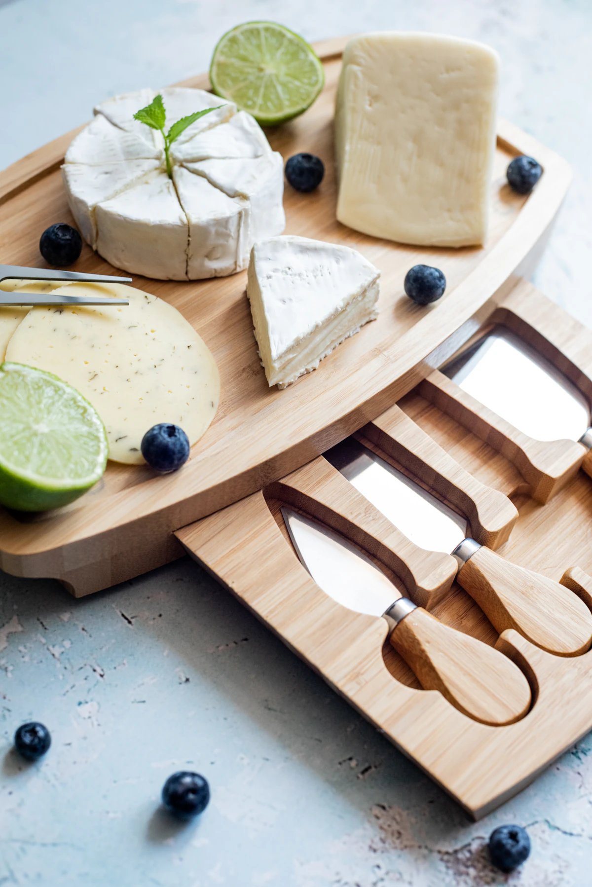 Cheese board with a full set of cheese knives and soft cheeses — choosing the right tool matters