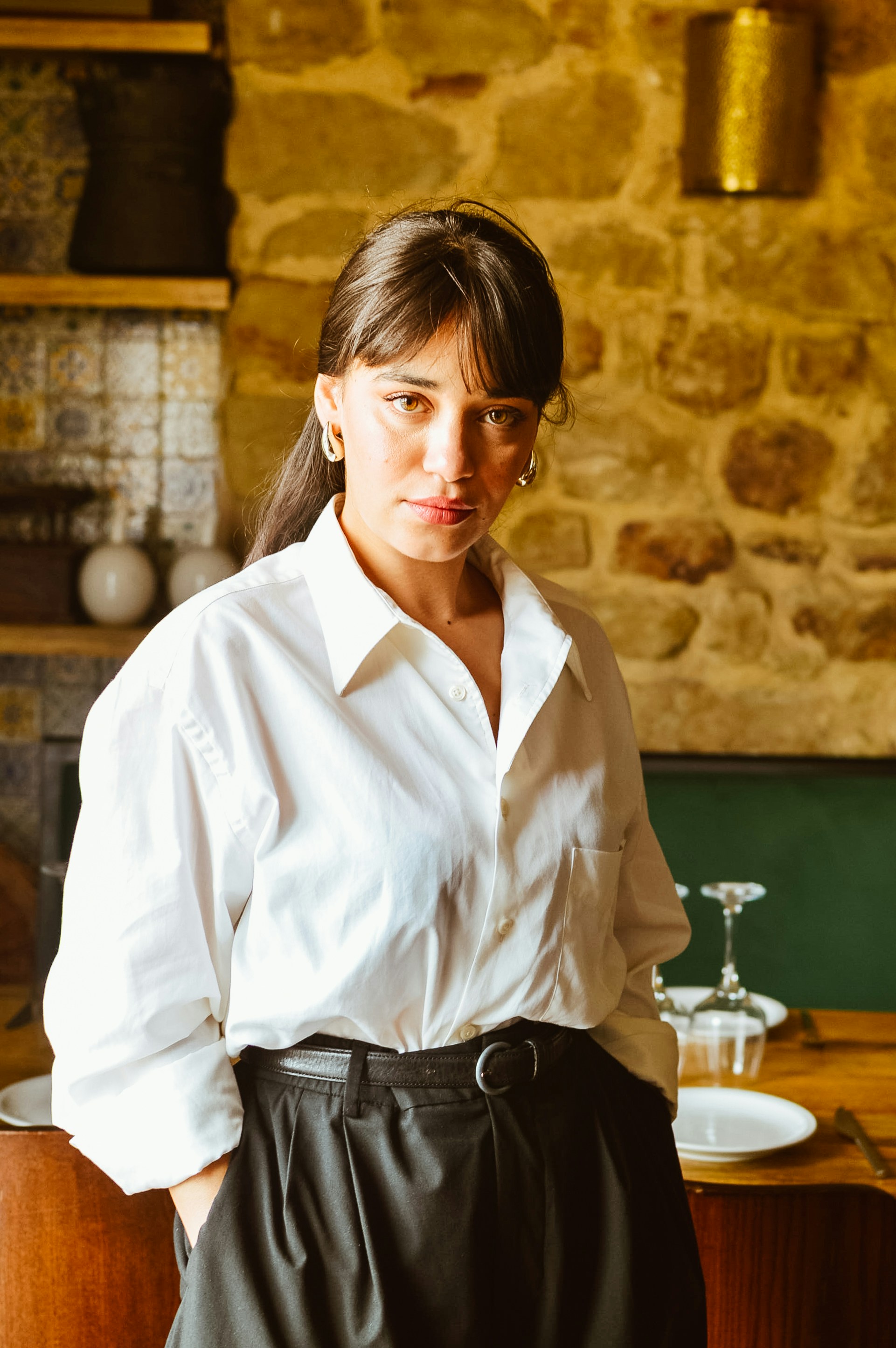 A woman in a white shirt and black skirt