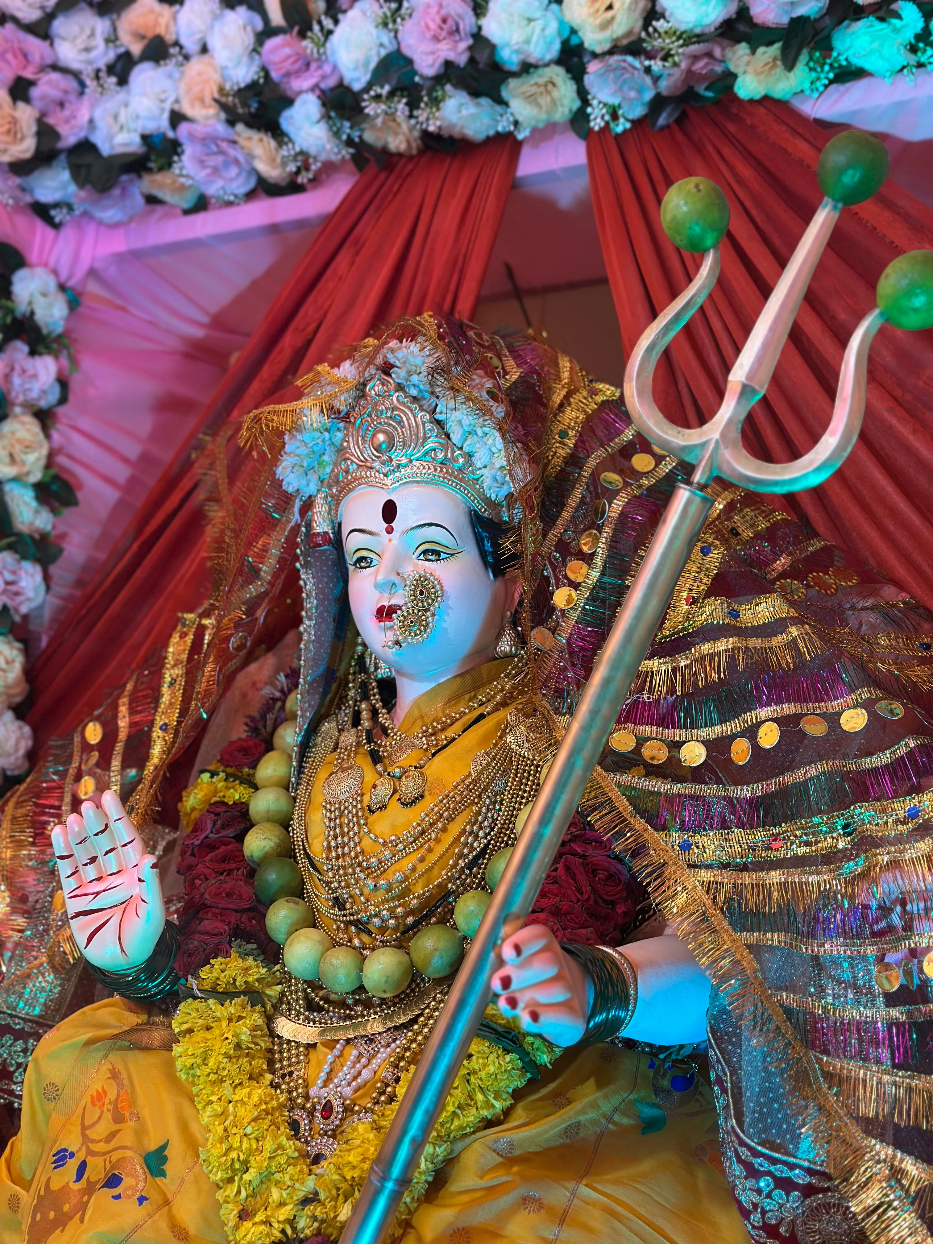 A statue of a hindu god with a staff