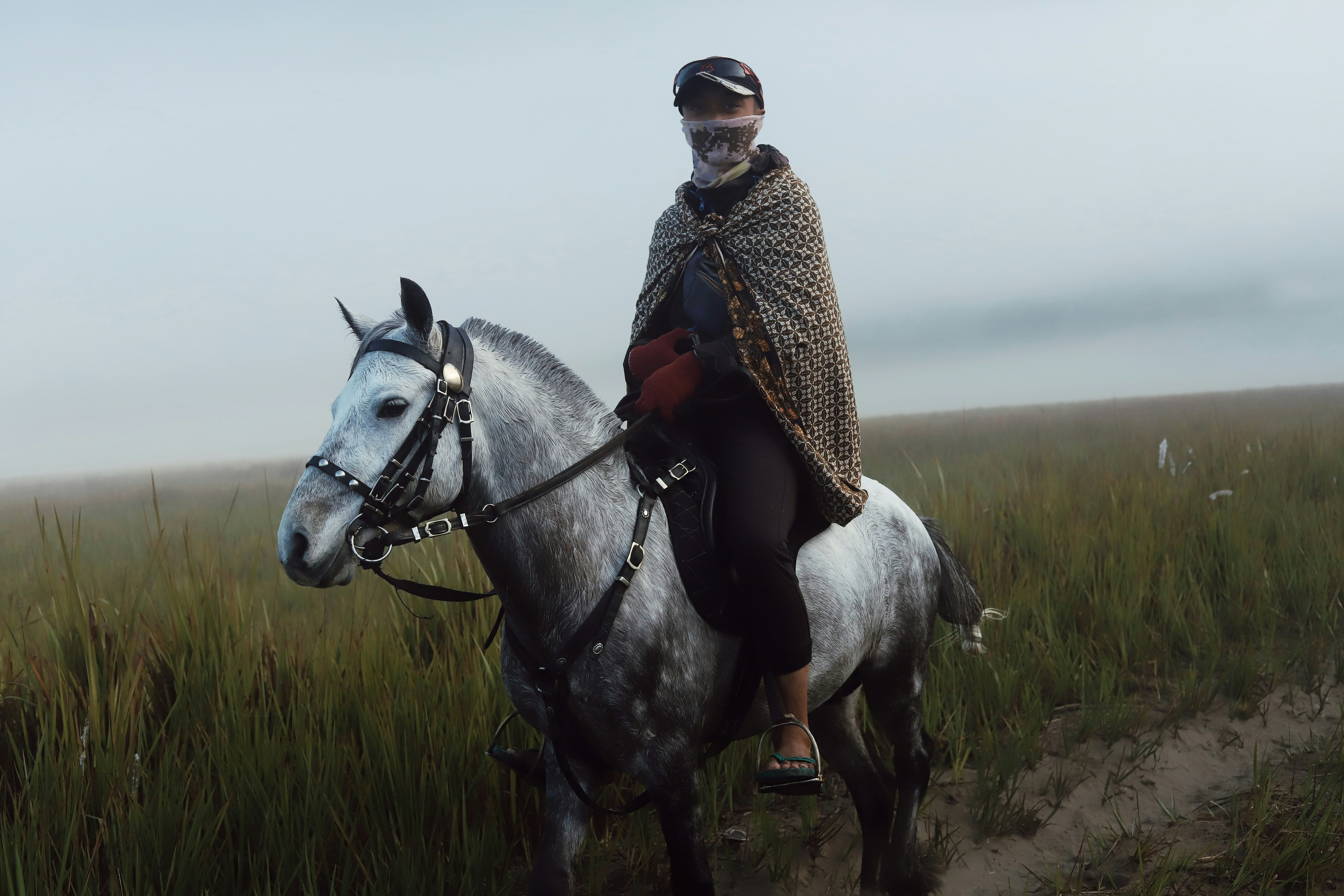 A man riding on the back of a white horse