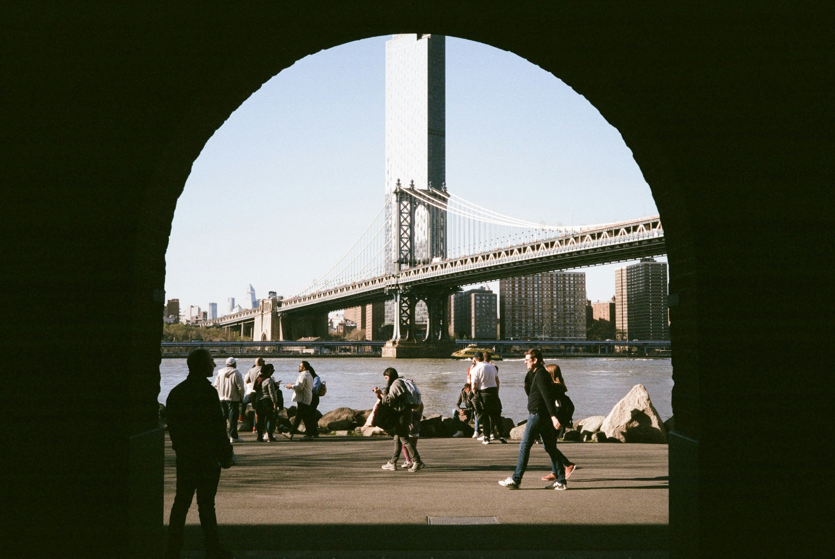 A group of people walking across a bridge photo – Free Dumbo Image on ...