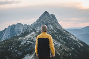 A man standing on top of a snow covered mountain