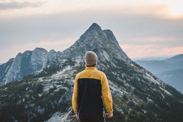 A man standing on top of a snow covered mountain