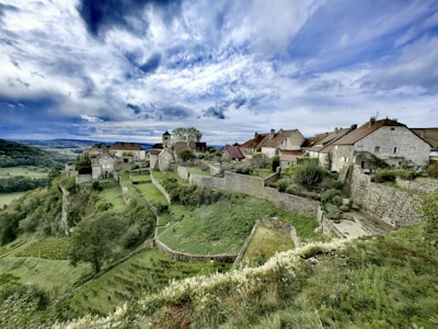 A scenic view of a village on a hill