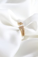 A white cloth with a gold ring on it