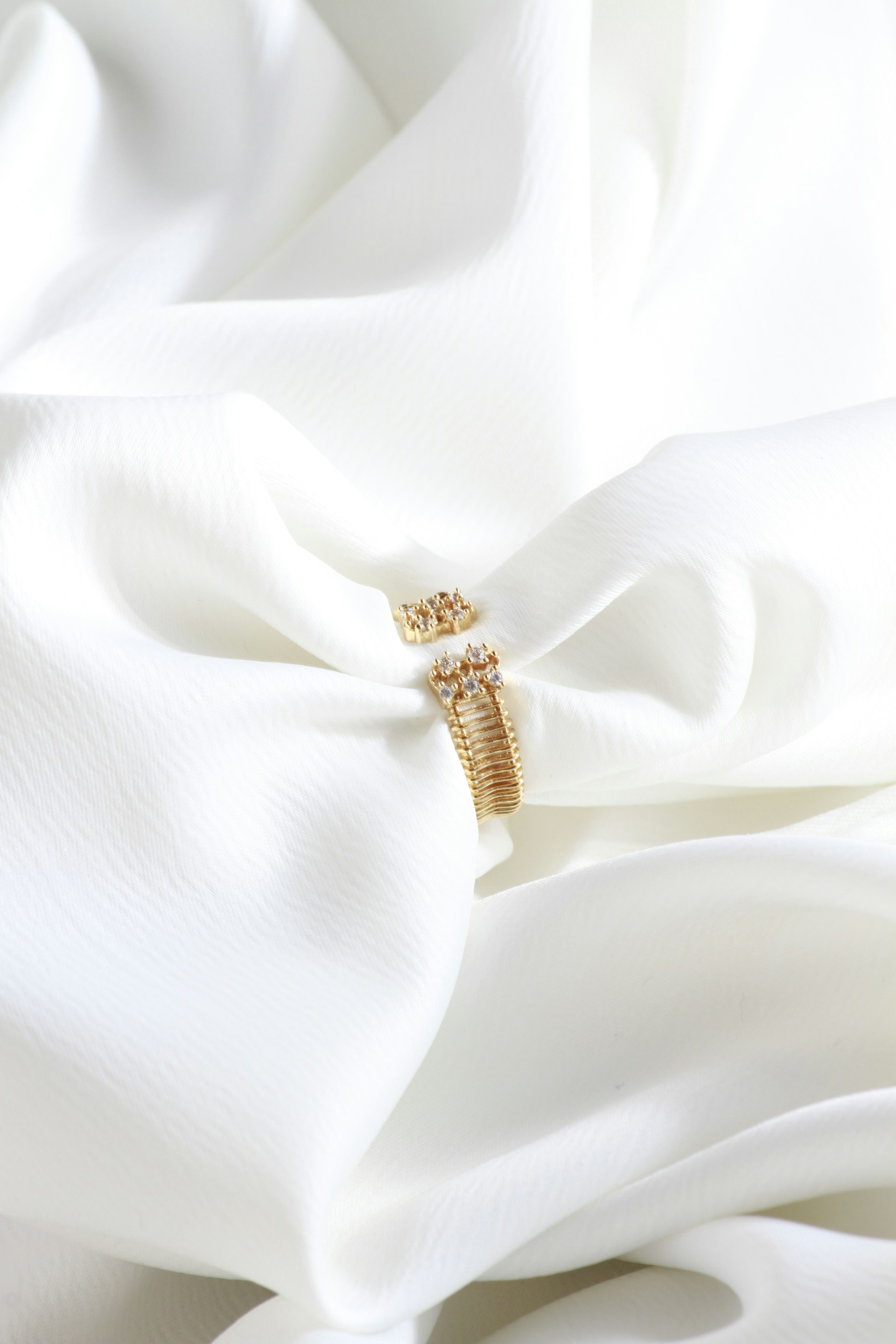 A white cloth with a gold ring on it