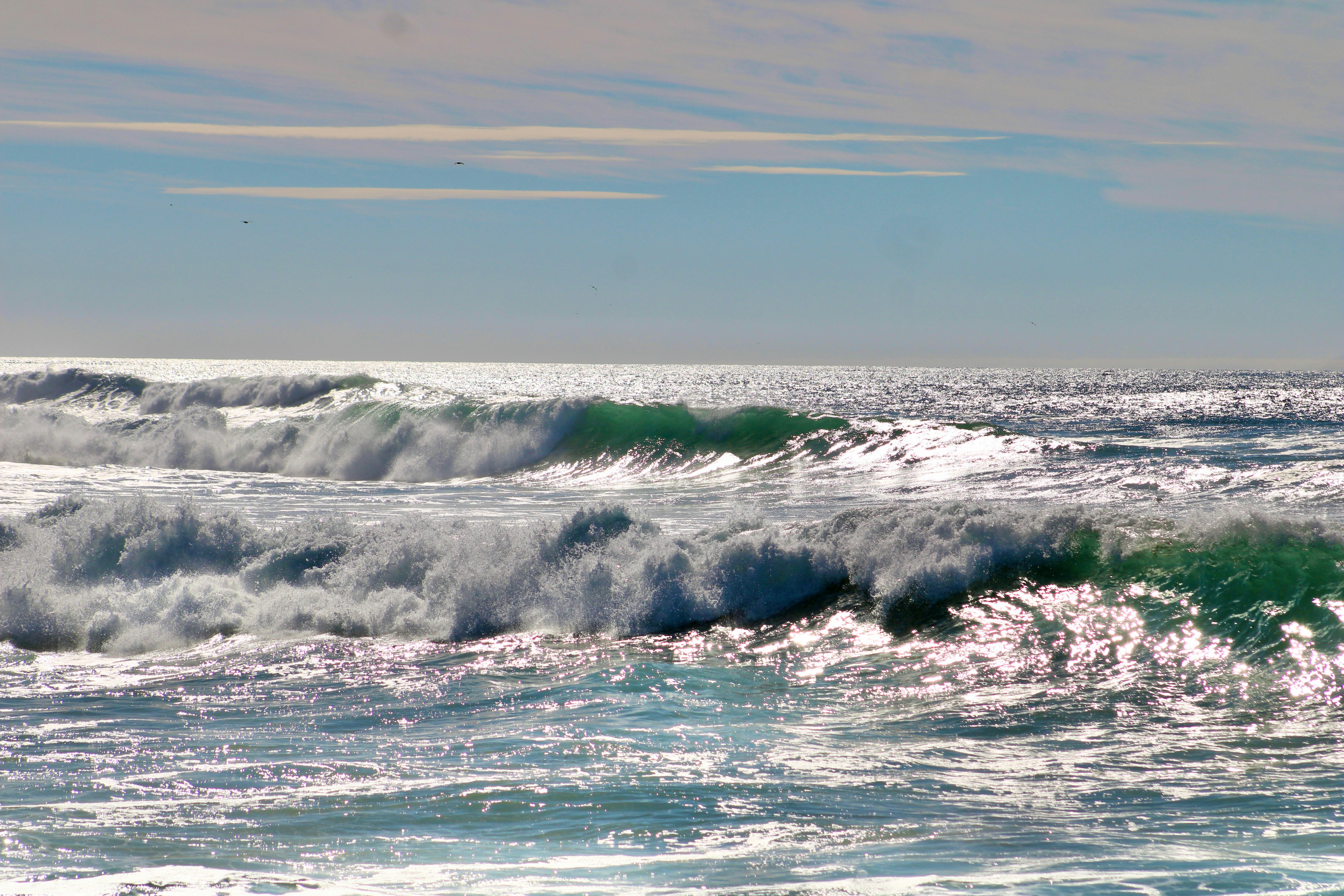 A man riding a wave on top of a surfboard