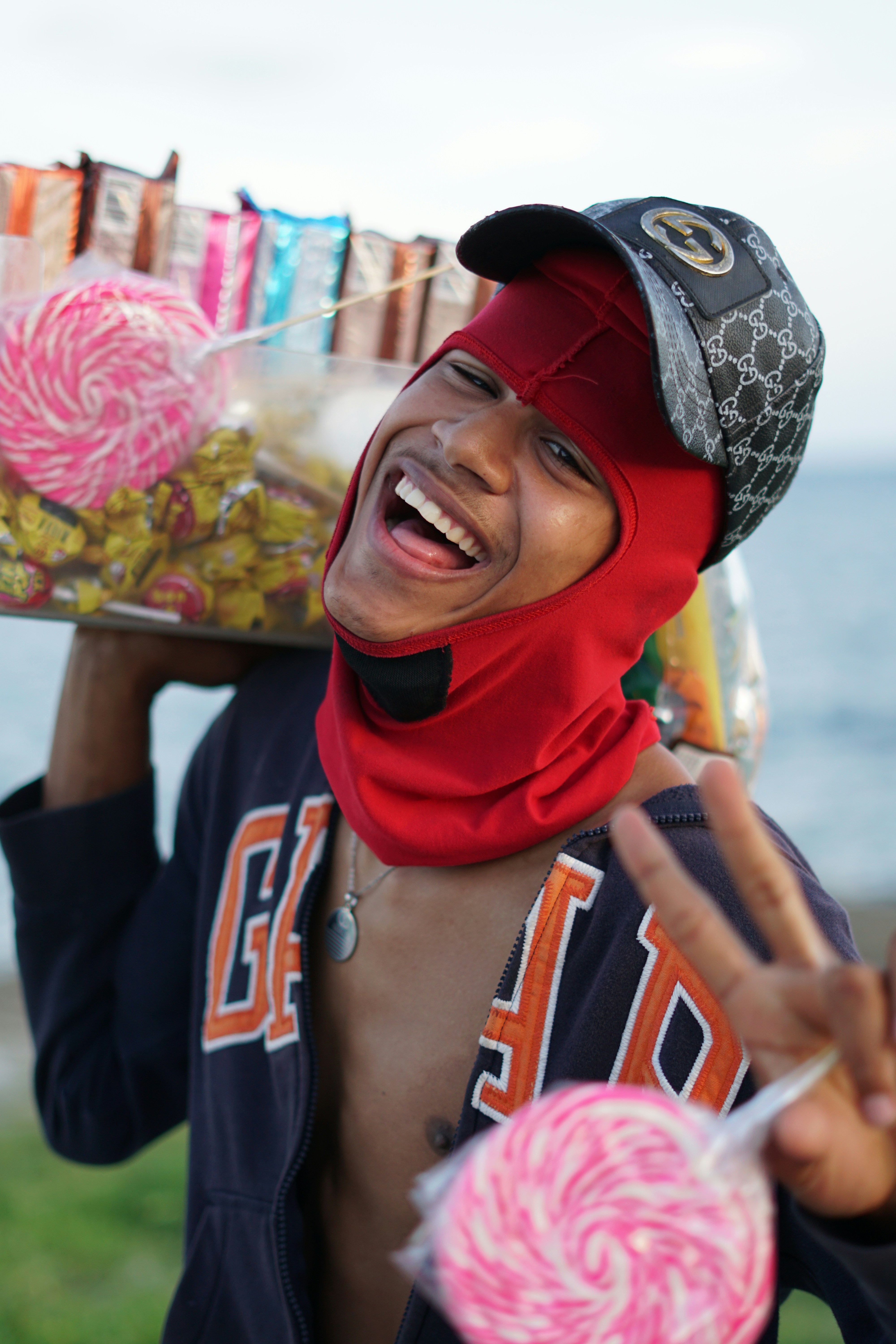 A man holding a tray full of candy and lollipops