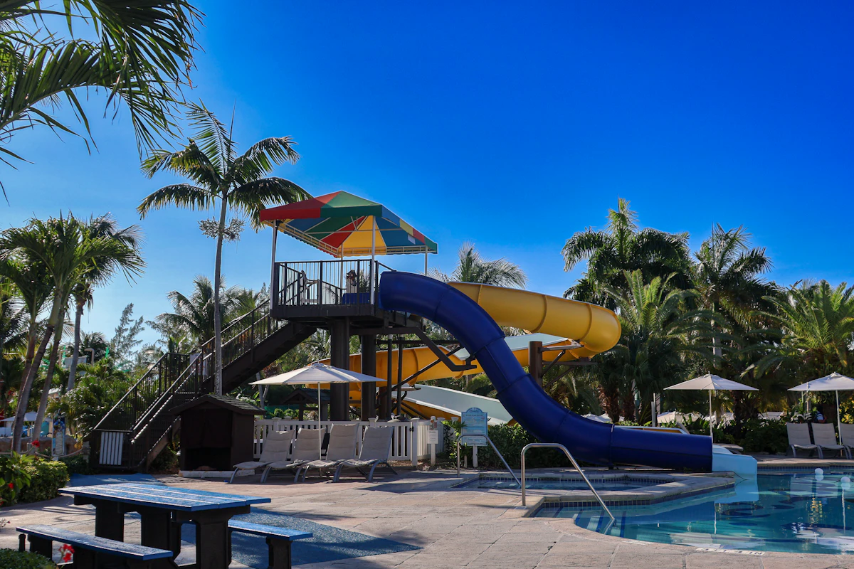 Water slide next to a resort swimming pool