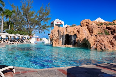 A large pool with a waterfall next to it