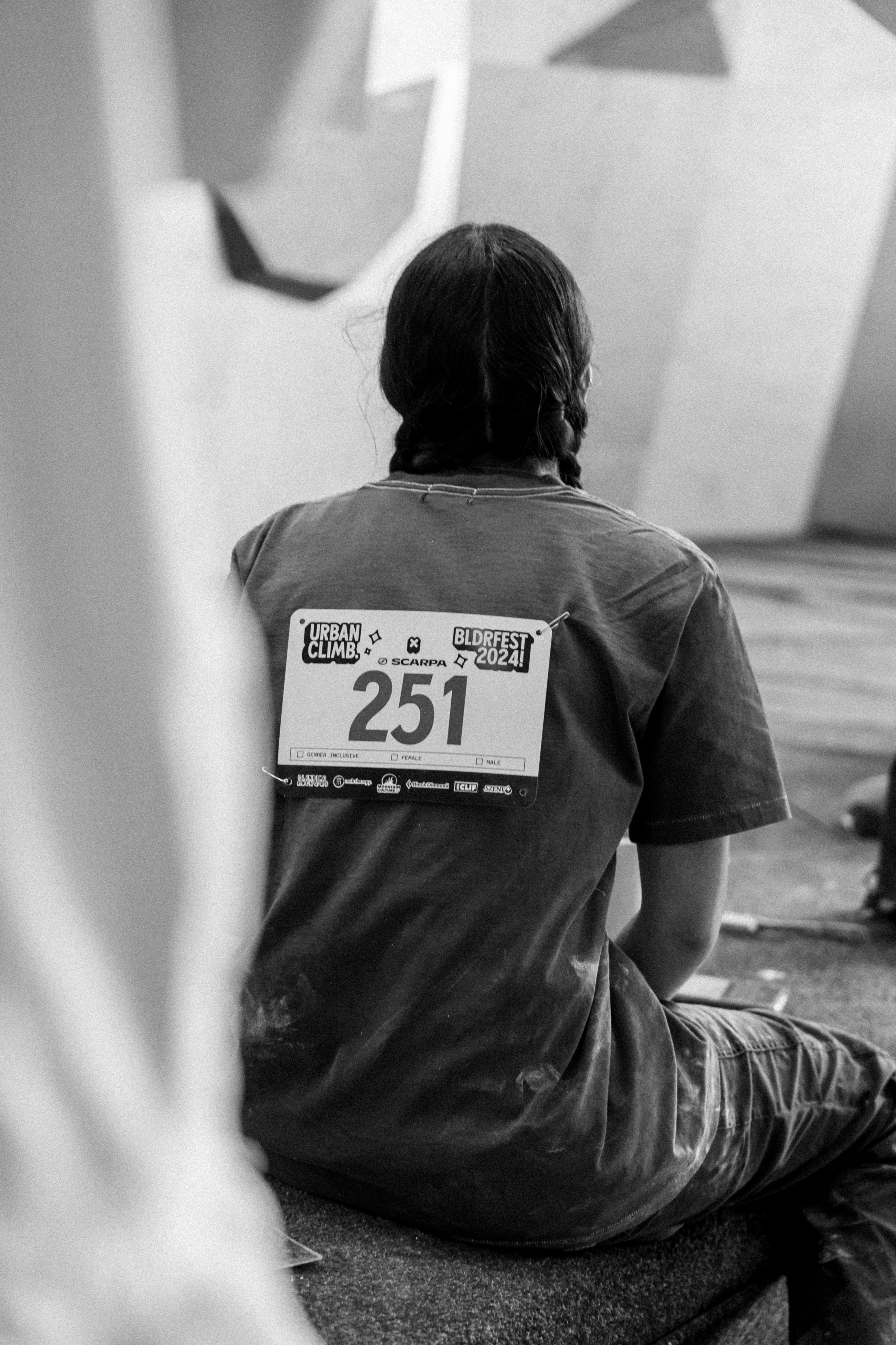A man sitting on the ground in front of a building