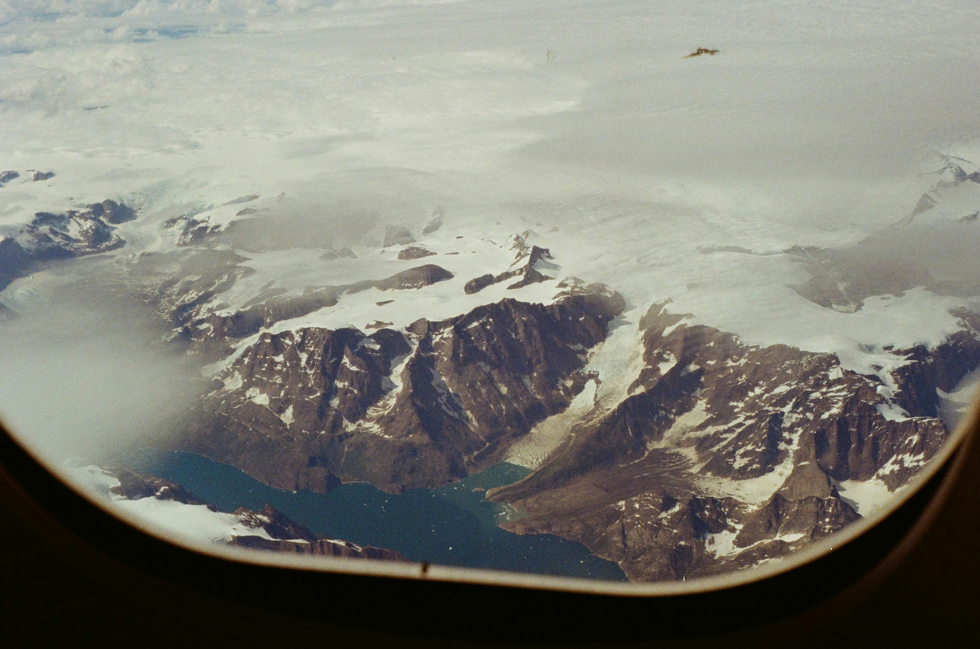 A view of a mountain range from an airplane window