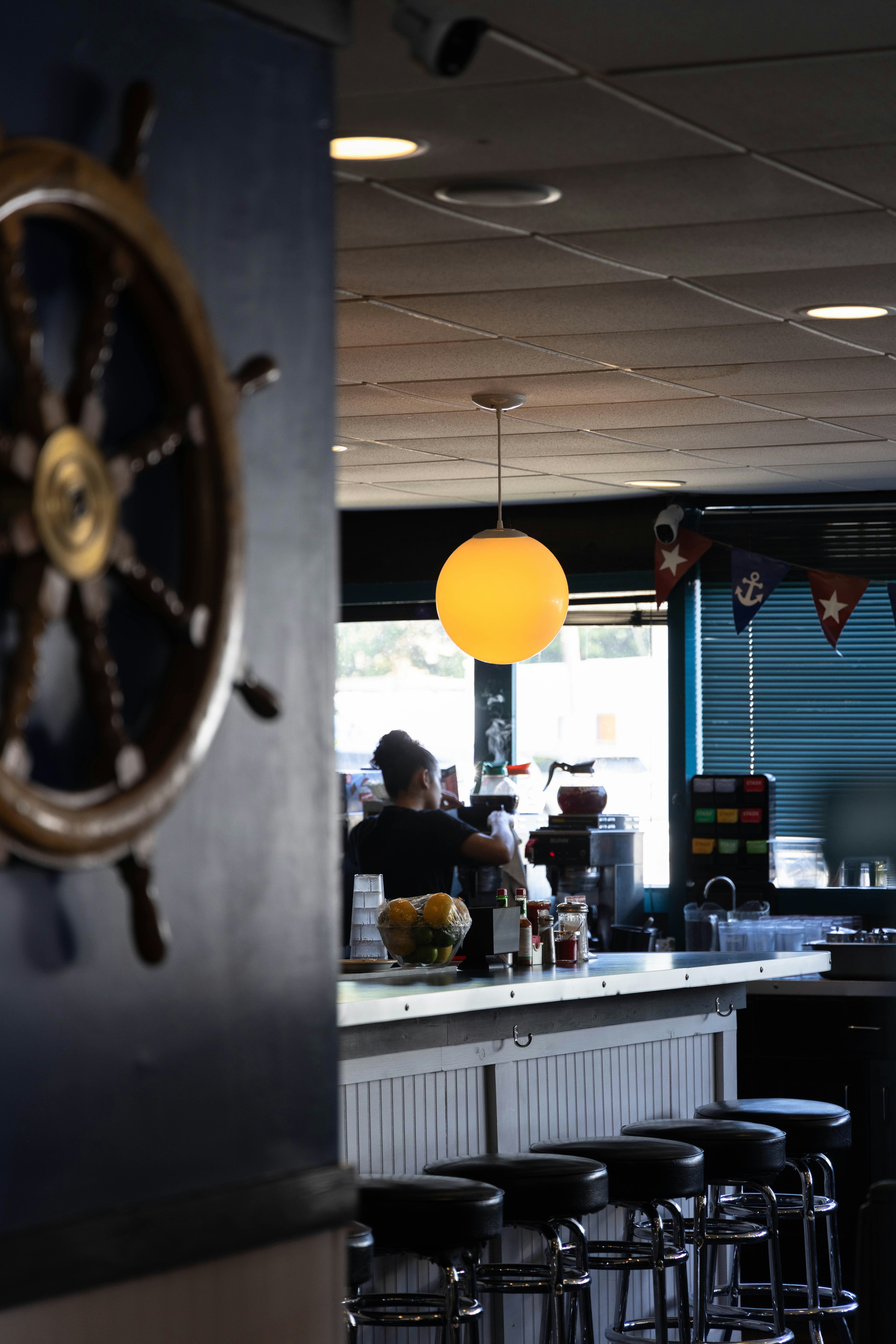 A restaurant with a bar and a steering wheel on the wall
