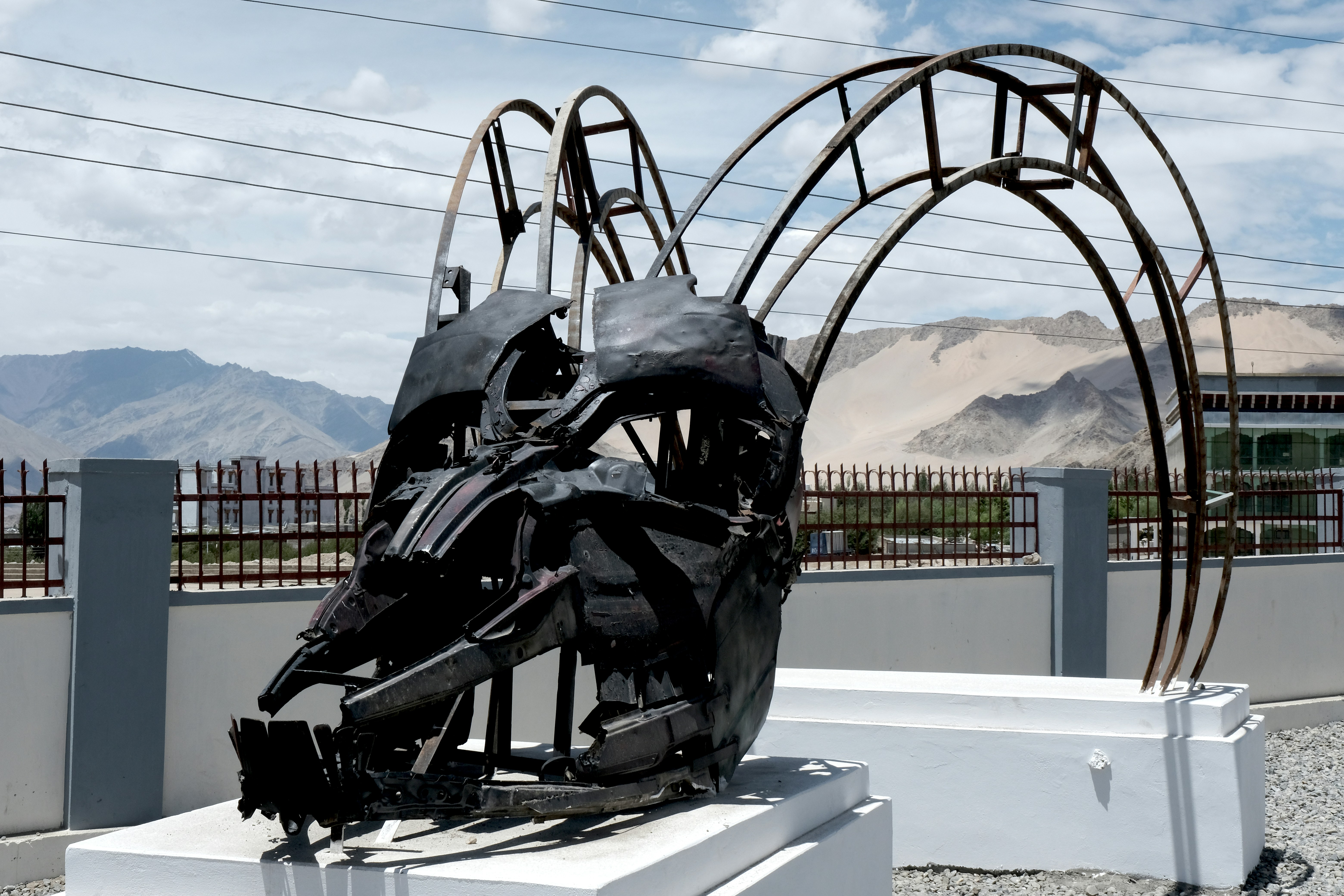 A sculpture is sitting on a white bench