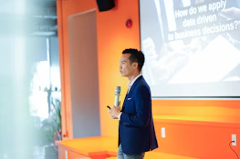 A man standing in front of a projector screen
