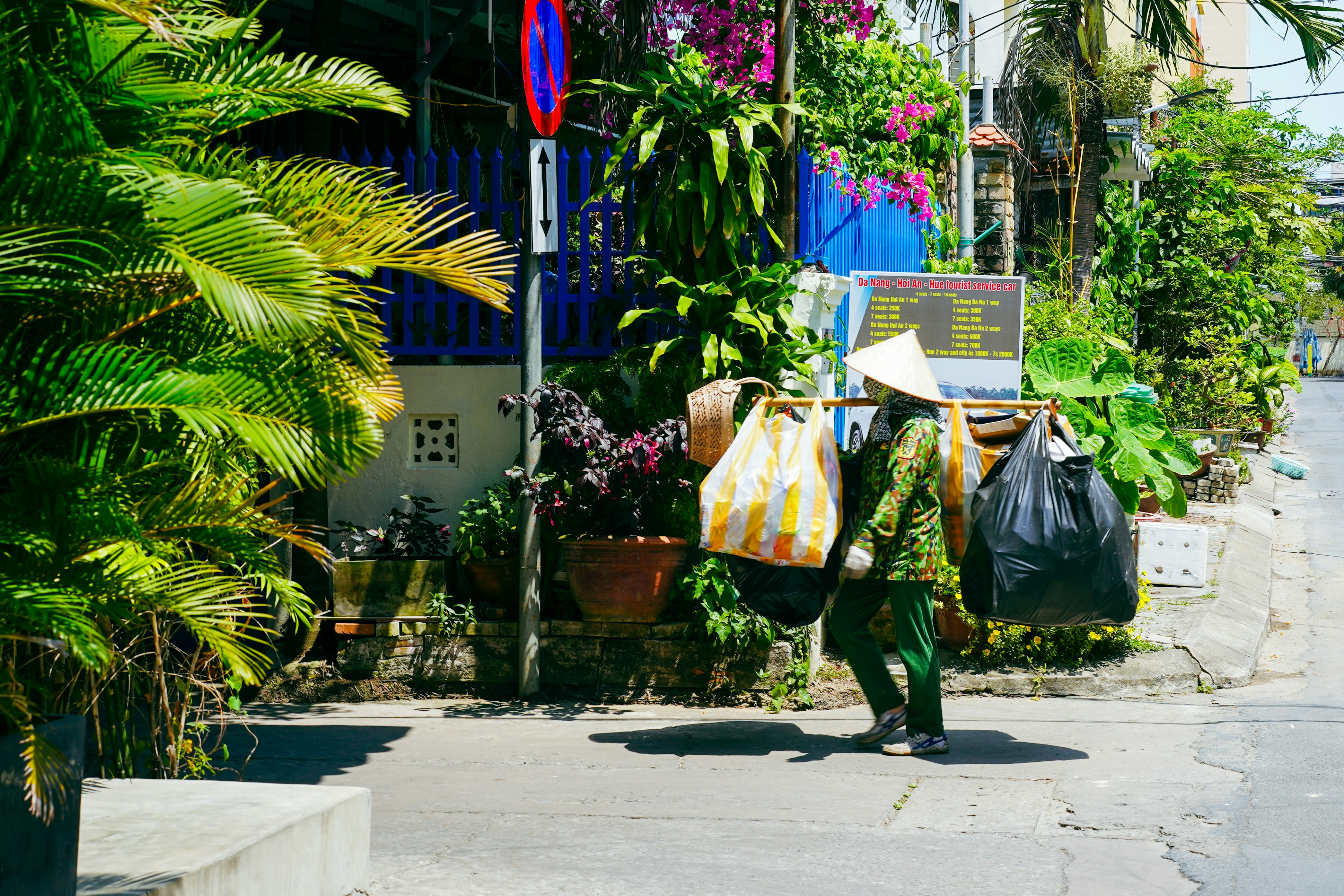 A person walking down a street carrying bags