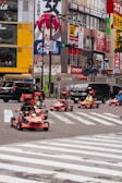 A group of people riding karts down a street