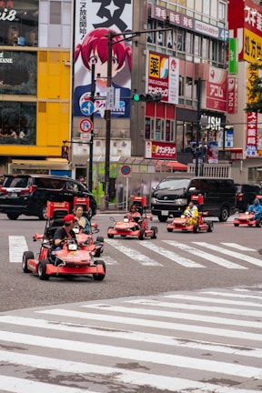 A group of people riding karts down a street