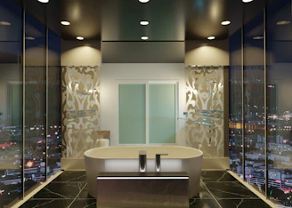 A bathroom with a tub and a large window