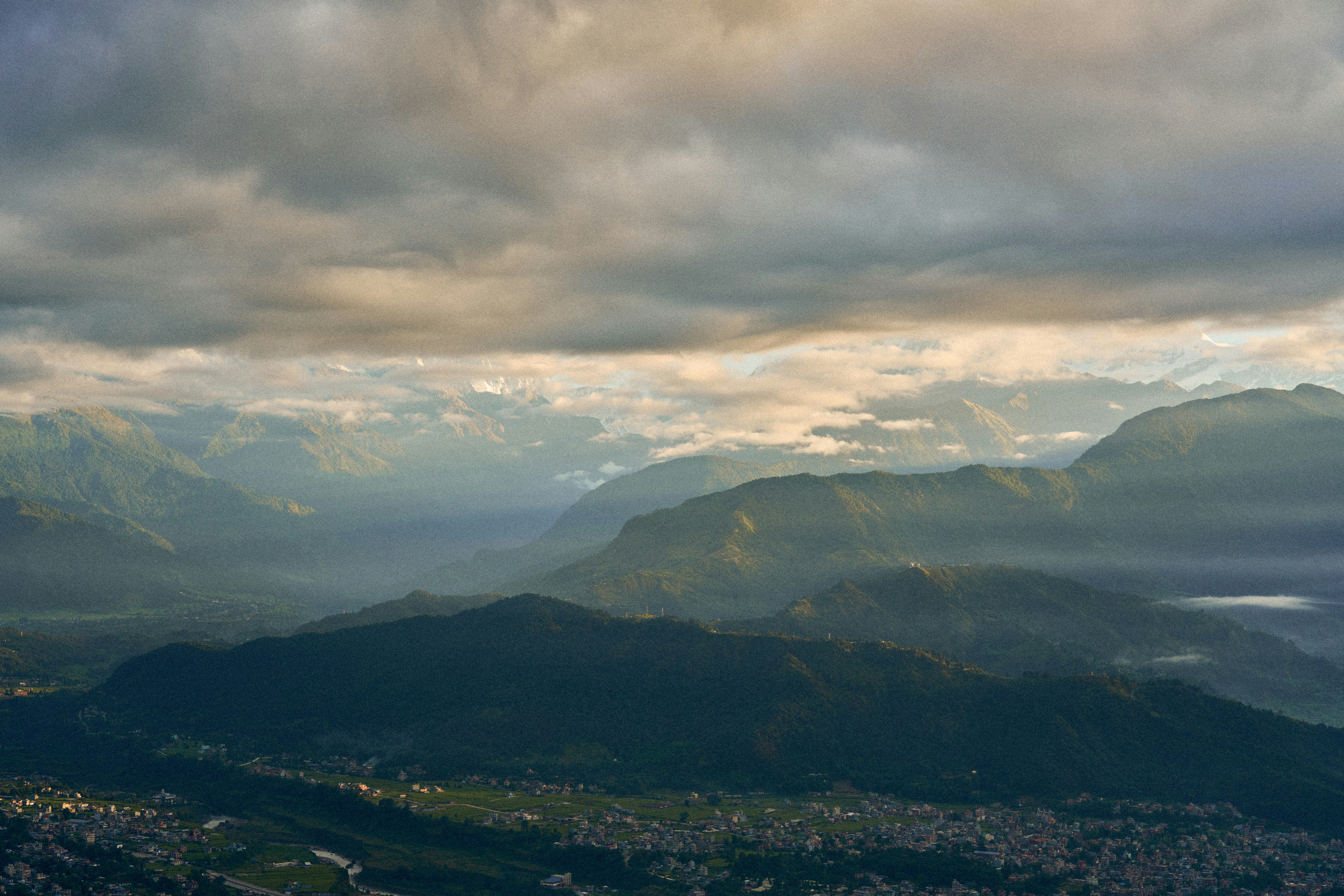 A view of a mountain range with a cloudy sky photo Free Nepal Image