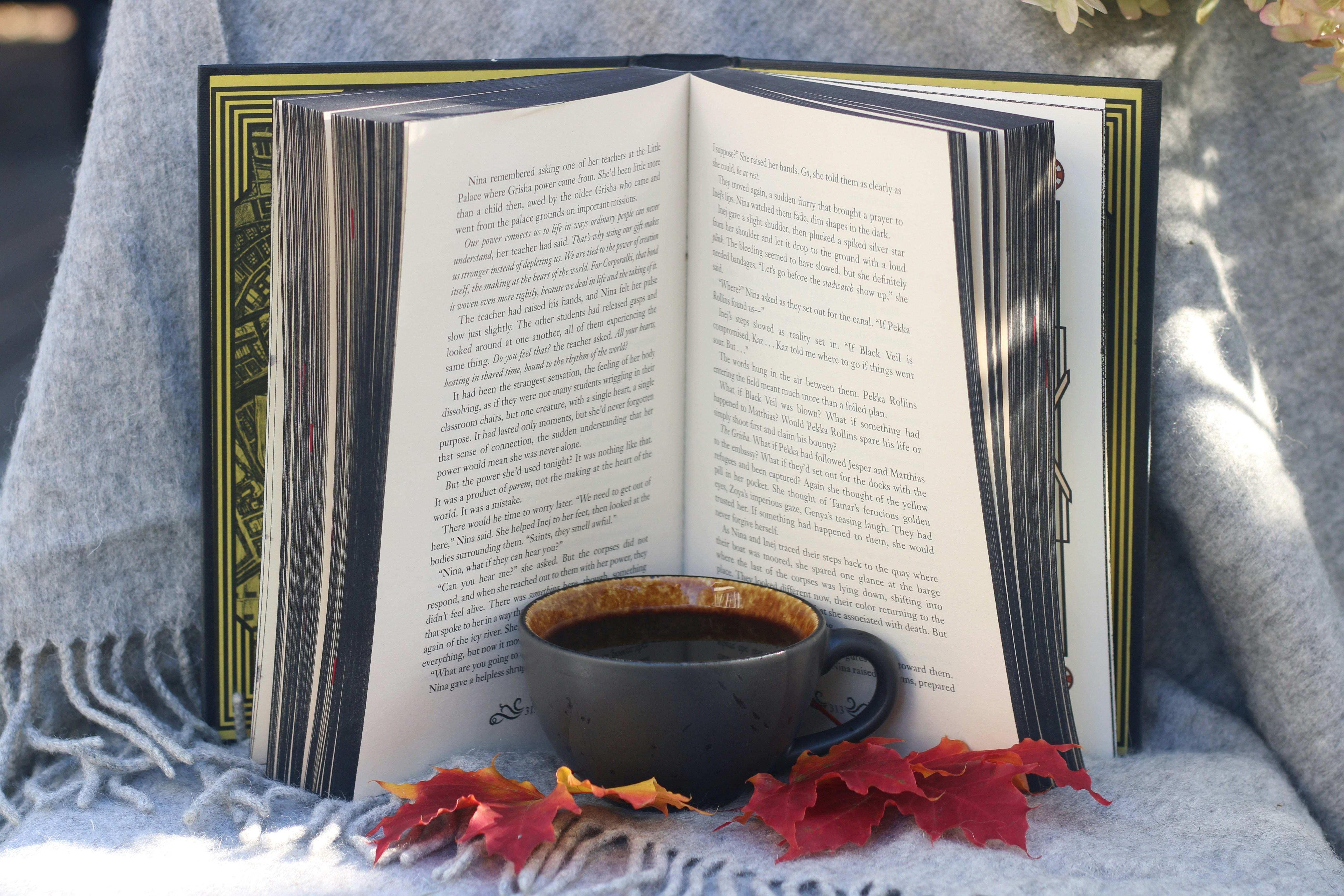 An open book with a cup of coffee on top of it