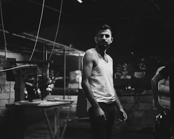 A man standing in a room next to a table