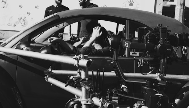 A black and white photo of some people in a car