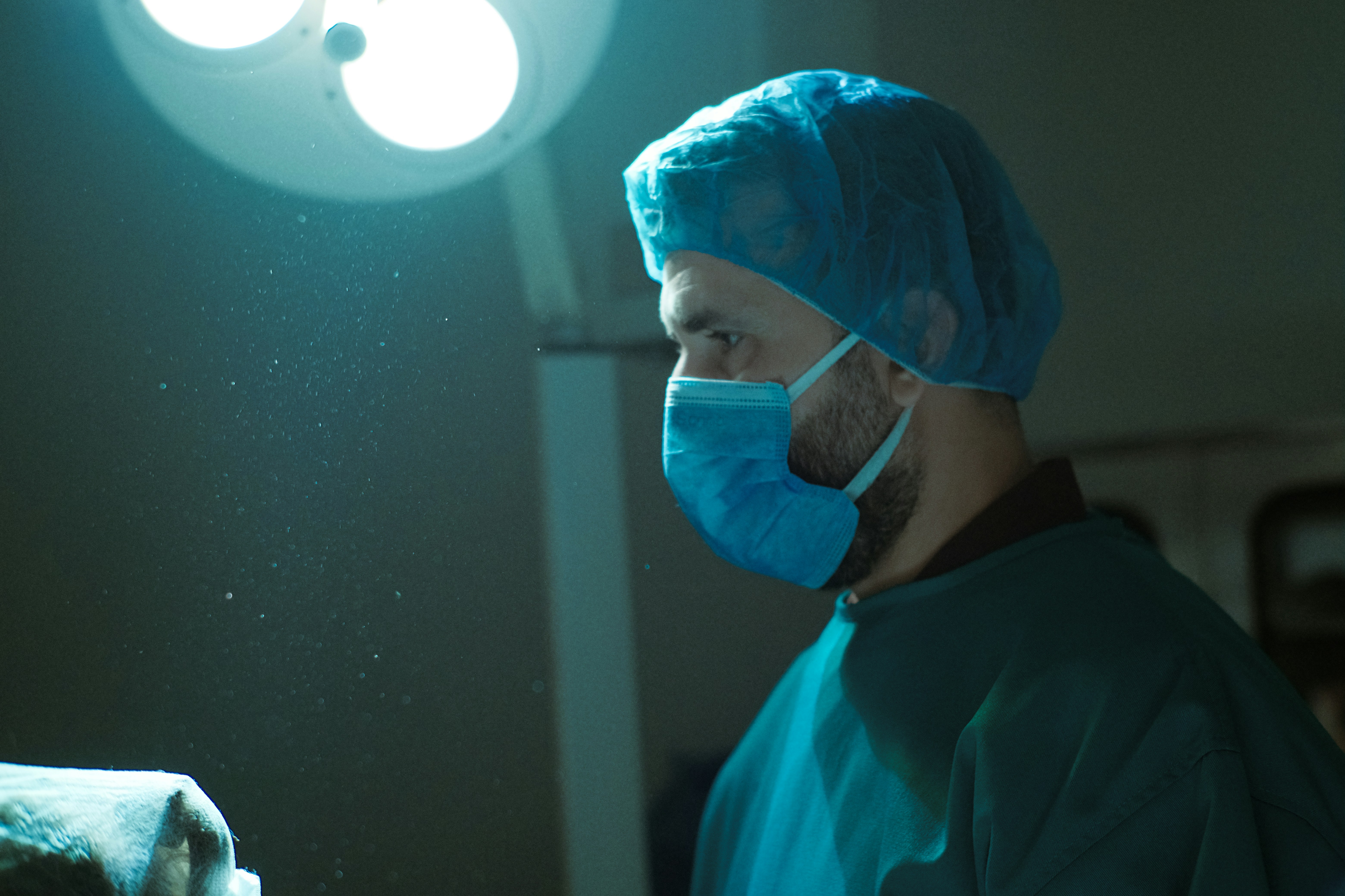 A man wearing a surgical mask in a room
